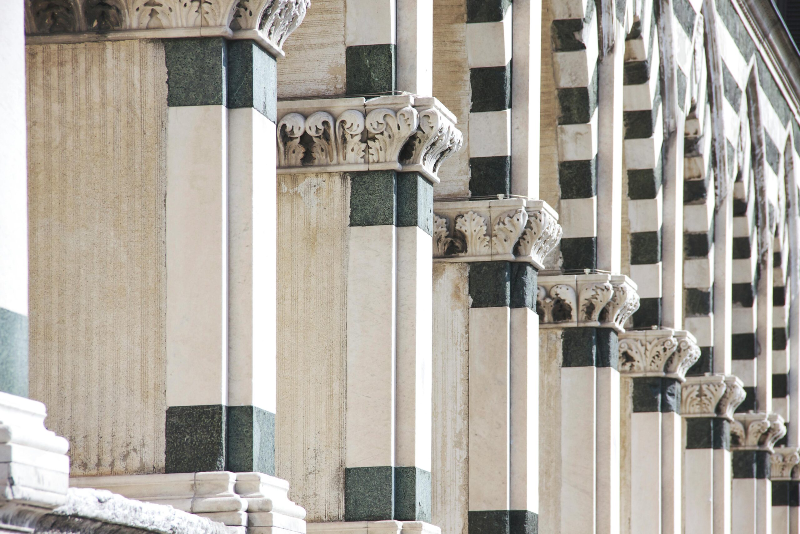 Products Close-up of marble columns in Florence, showcasing ornate carvings and classic architecture.