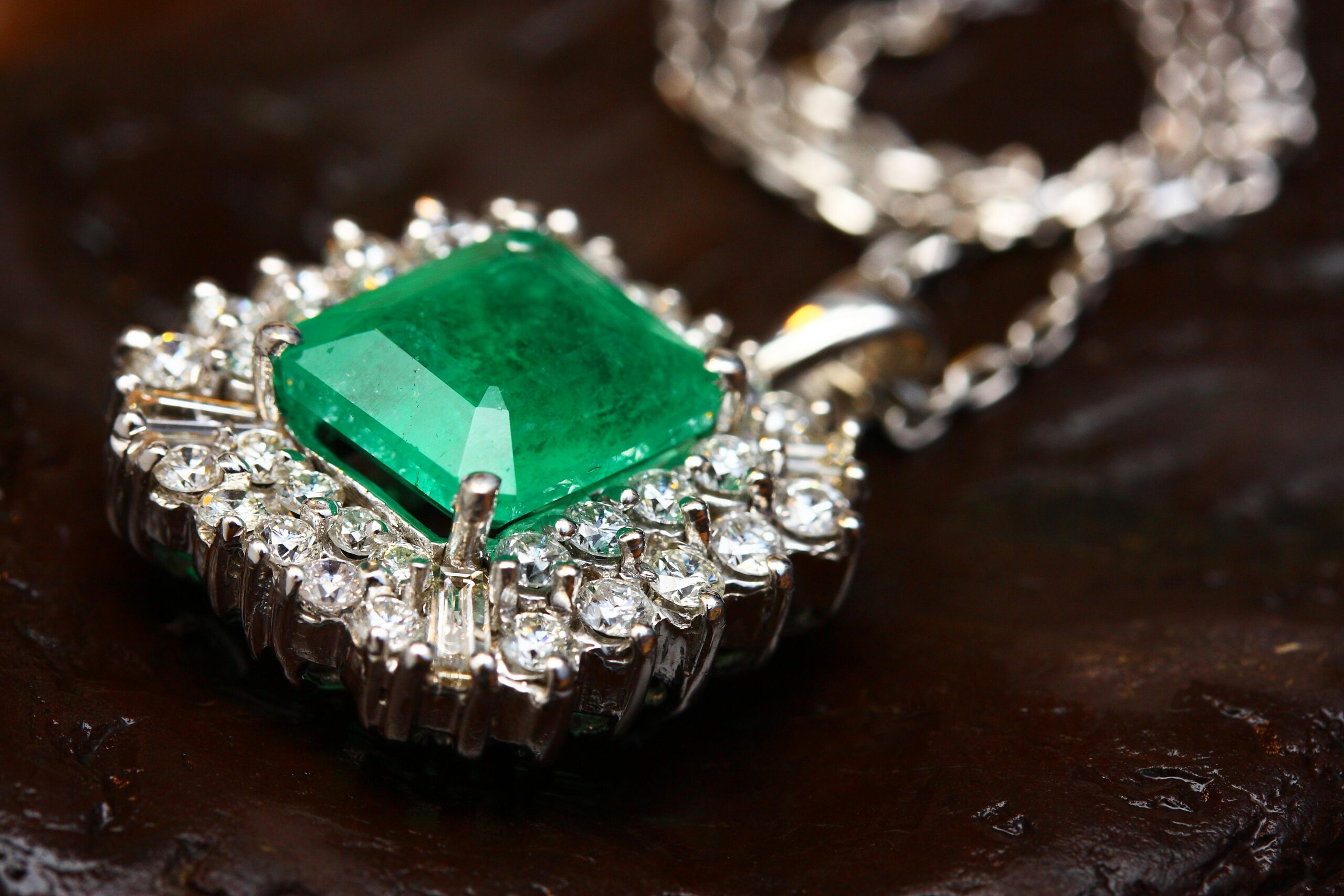 Products Stunning emerald pendant necklace in white gold with shimmering diamonds, epitomizing luxury and elegance.
