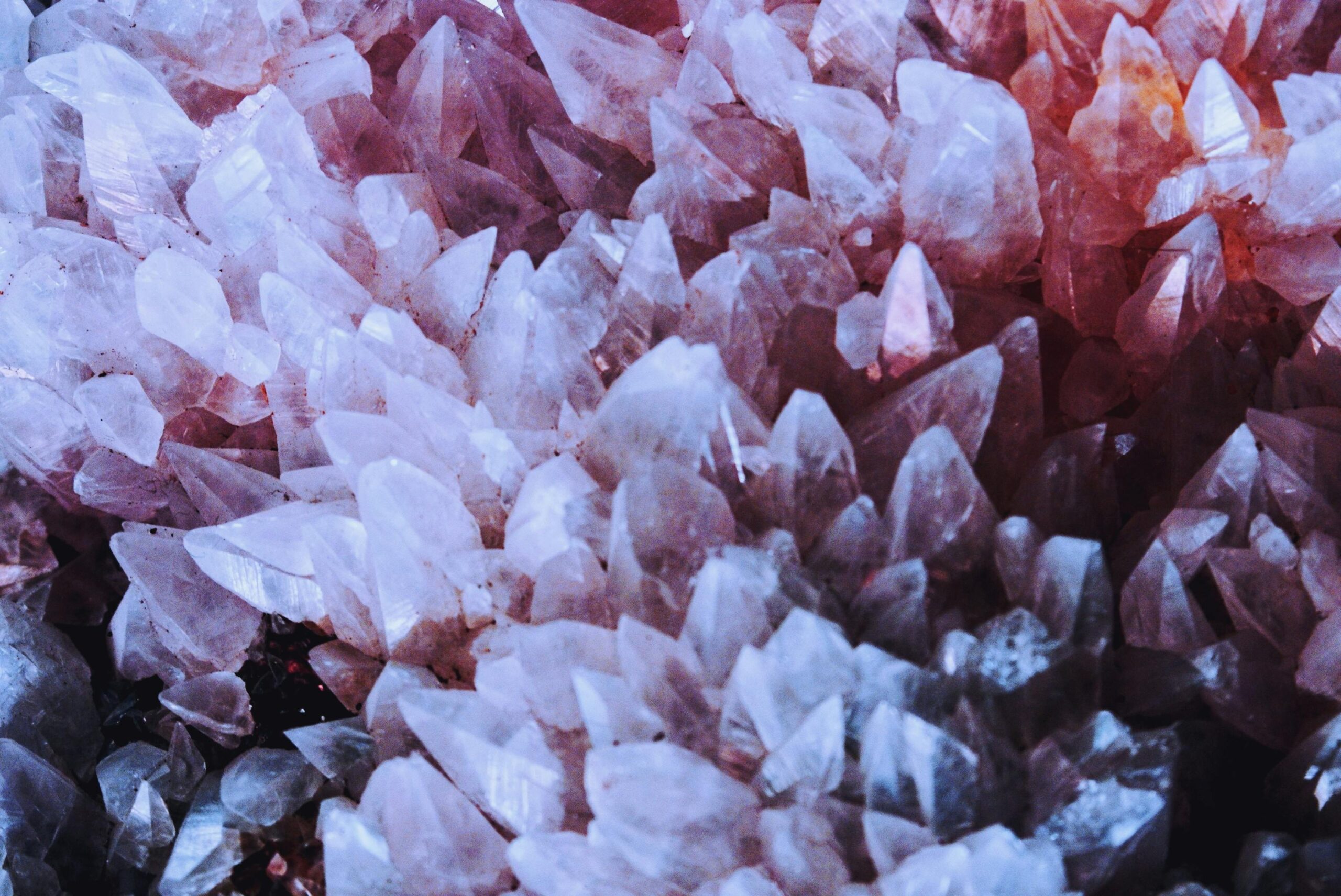 Products A stunning close-up of naturally occurring pink quartz crystals with sharp details.