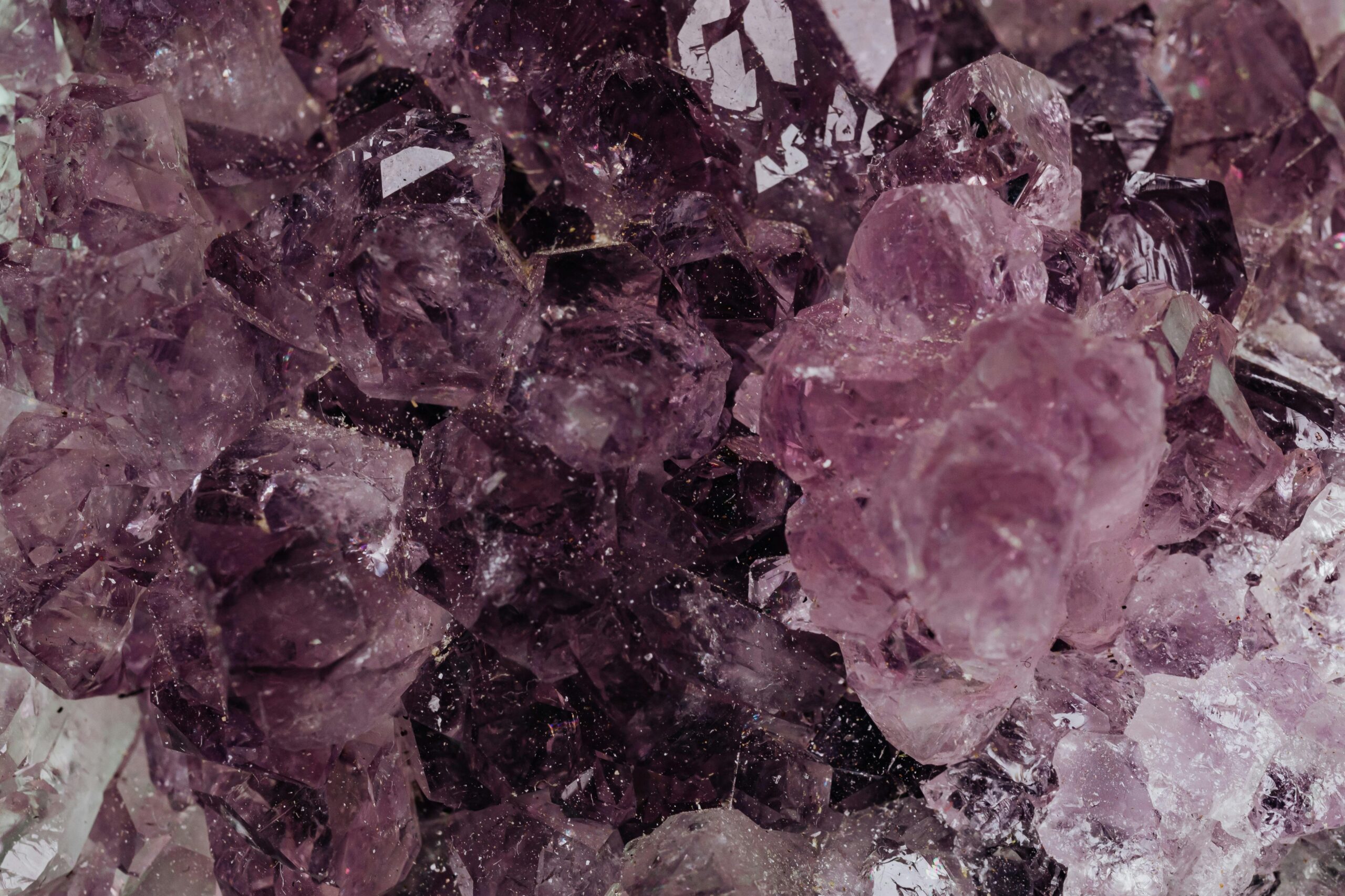 Products Detailed close-up of amethyst crystals showcasing their rich textures and deep colors.