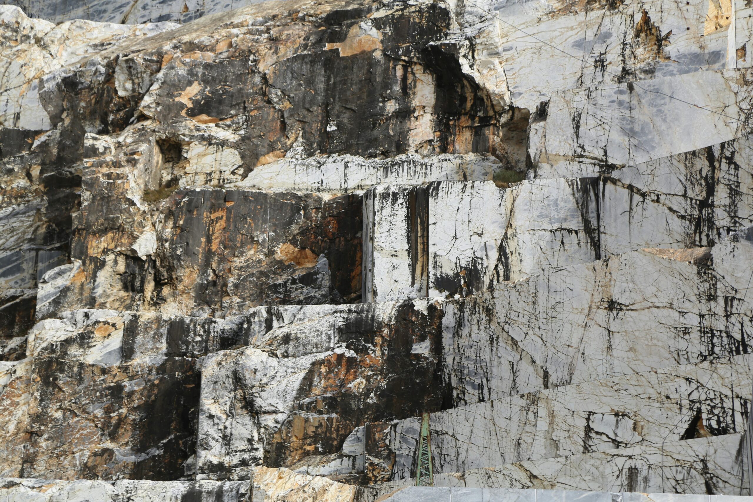 Products Close-up of Carrara marble quarry showcasing rock textures and patterns.
